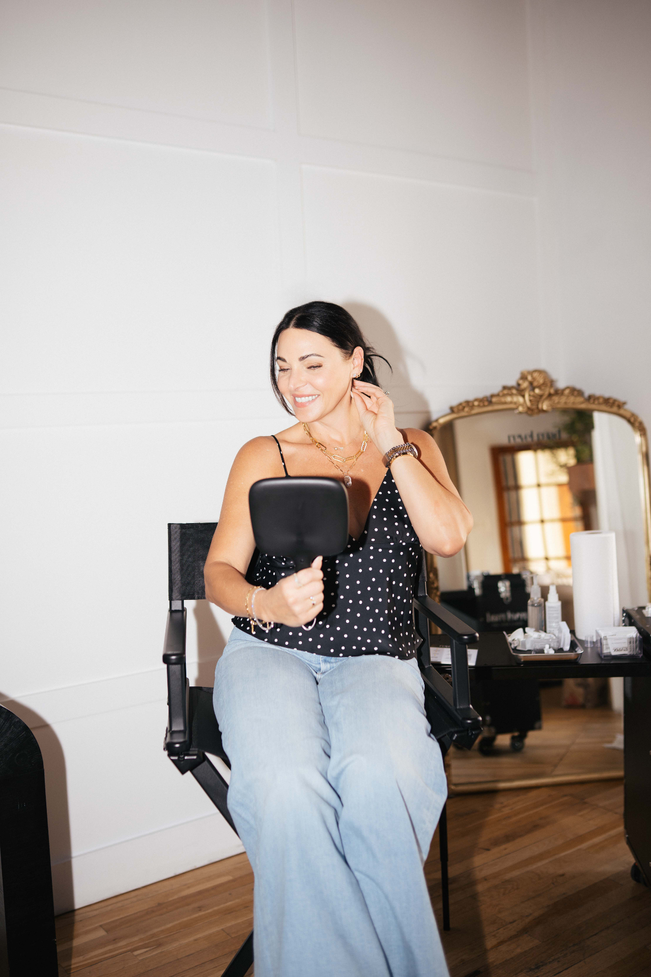 Guest admiring her new piercing in the styling chair